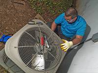 expert works on outdoor HVAC Edison